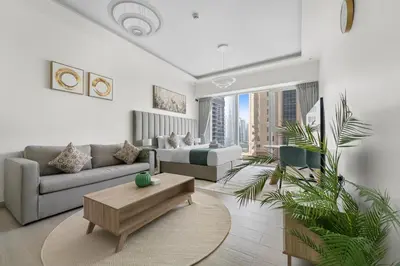 a living room with a couch and a coffee table at Stonetree - Brand New Studio - Prime Location in Dubai