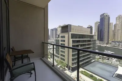 a balcony with a desk and a view of a city at Dubai Marina Walking distance to metro Marina View in Dubai