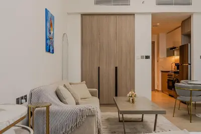 a living room with a couch and a table at Cozy Studio in JLT I Medore in Dubai