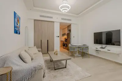 a living room with a couch and a table at Cozy Studio in JLT I Medore in Dubai