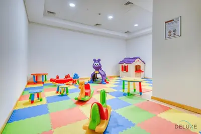 a room with a play area with colourful tables and chairs at Charming 1BR Apartment in Sparkle Tower 1, Dubai Marina by Deluxe Holiday Homes in Dubai