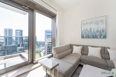 a living room with a couch and a large window at Charming 1BR Apartment in Sparkle Tower 1, Dubai Marina by Deluxe Holiday Homes in Dubai