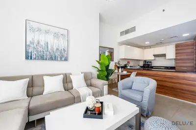 a living room with a couch and a table at Charming 1BR Apartment in Sparkle Tower 1, Dubai Marina by Deluxe Holiday Homes in Dubai
