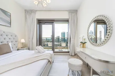 a bedroom with a bed and a mirror and a window at Charming 1BR Apartment in Sparkle Tower 1, Dubai Marina by Deluxe Holiday Homes in Dubai