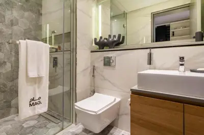 a bathroom with a sink and a toilet and a mirror at City Retreat MAG 318,Downtown Dubai 5 minutes walk to Dubai mall in Dubai
