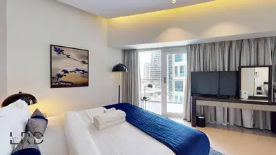 a bedroom with a large bed and a large window at Luxury Studio in Business Bay in Dubai