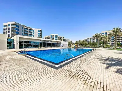 a large swimming pool in front of a building at Chic Urban Escape at Studio MAG 422 in Dubai
