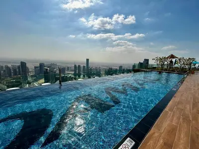 a swimming pool on the roof of a building at Luxury Stay with Burj Khalifa Views & Infinity Pool in Dubai