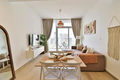 a living room with a table and a couch at Bohemian Bliss 1 BR Apartment in Dubai