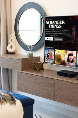 a mirror and a dresser in a room at SmartStay at Carson Tower - Panoramic City Views - Modern Luxury Apartments in Dubai