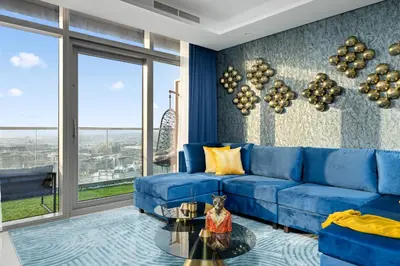 a living room with a blue couch and a glass table at Amazing 2BR Apartment in Paramount Hotel Midtown, 64th-Floor Infinity Pool & Burj Khalifa Views in Dubai