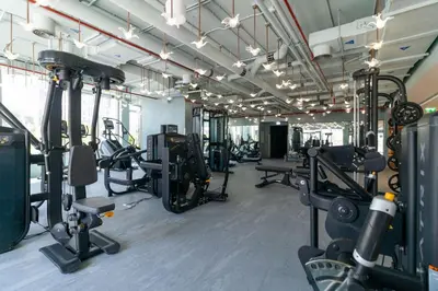 a gym with several treadmills and cardio machines at Elegant MAG 318 Studio Near Dubai Mall in Dubai