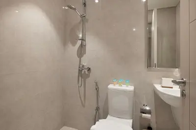 a bathroom with a shower and a toilet and a sink at Lux 3BR With Spectacular Downtown Views in Dubai