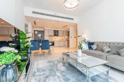 a living room with a couch and a table at Luxury Sunrise Bay 1BR - Panoramic Sea View with Exclusive Amenities, by Think Realty in Dubai