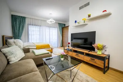 a living room with a couch and a tv at Dubai marina - Luxury Studio Apartment in Dubai