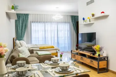 a living room with a couch and a tv at Dubai marina - Luxury Studio Apartment in Dubai