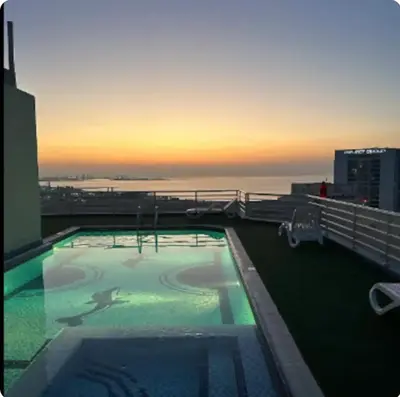 a swimming pool on top of a building with the ocean at Great Location in Dubai Marina!! in Dubai