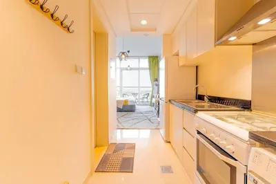 a kitchen with a sink and a stove top oven at Elegant Studio in Damac Hills - Exclusive Living with Premium Amenities, Managed by Think Realty in Dubai