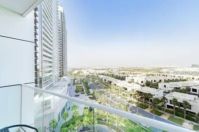 a view of a city from the balcony of a building at Elegant Studio in Damac Hills - Exclusive Living with Premium Amenities, Managed by Think Realty in Dubai