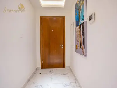 a hallway with a wooden door in a room at Modern High Floor Canal View1 BHK in Dubai