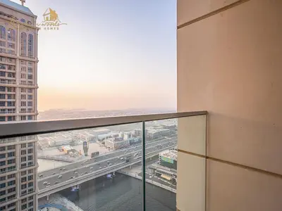 a view of a city from the balcony of a building at Modern High Floor Canal View1 BHK in Dubai