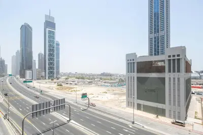 a highway in the middle of a city with tall buildings at Frank Porter - The Lofts Central Tower in Dubai