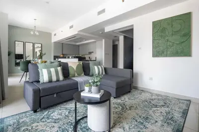 a living room with a couch and a table at Frank Porter - The Lofts Central Tower in Dubai