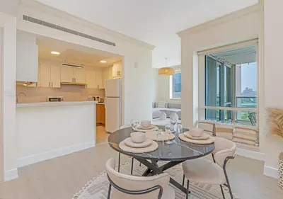 a kitchen and dining room with a glass table and chairs at 2BR Dubai Marina Apt - Walk to Metro - Pool and Gym in Dubai