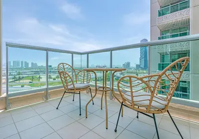 a balcony with a table and chairs and a view of the city at 2BR Dubai Marina Apt - Walk to Metro - Pool and Gym in Dubai