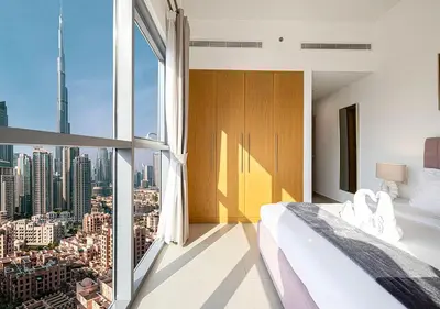 a bedroom with a view of a city at Magnificent 4 Bedroom Apartment, Bellevue Tower in Dubai