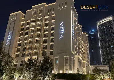 a large building with a sign on the side of it at Luxurious 1 Bed in Dubai Creek Harbor, Hosted by Desert City Stays in Dubai