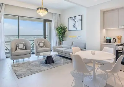 a living room with a couch and a table and chairs at Luxurious 1 Bed in Dubai Creek Harbor, Hosted by Desert City Stays in Dubai