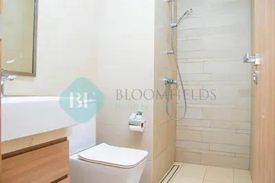 a bathroom with a shower with a toilet and a sink at Bloomfields 1br Azizi Gardens Meydan in Dubai