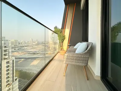 a balcony with a chair and a view of a city at Shadow Lounge Suites Work Station & Dubai Skyline Views in Dubai