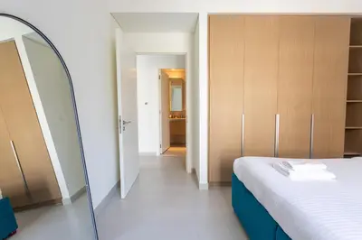 a bedroom with a bed and a mirror in it at Elegant 1 Bedroom at Creek Beach Bayshore in Dubai
