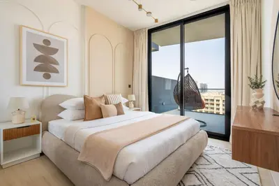 a bedroom with a large bed and a large window at GuestReady - Charming haven at Binghatti Crest in Dubai