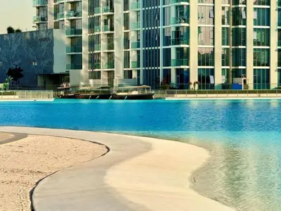 a beach in front of some tall buildings at Residences 29 - Divine Beachfront One Bedroom in Dubai