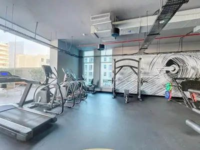 a fitness room with cardio equipment in a building at Studio One - Gorgeous Studio in Dubai