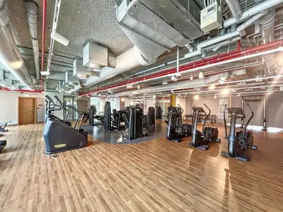 a gym with treadmills and cardio equipment in a building at Downtown Views II, Tower 2- Calm One Bedroom in Dubai