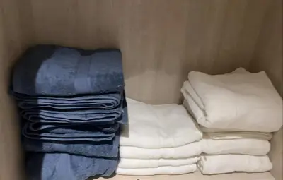 a group of towels are stacked in a closet at SevenPalm 2BR SeaView RooftopPool privBeach in Dubai