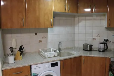 a kitchen with a sink and a washing machine at Newly furnished 1 Bedroom, high floor, amazing view, close to metro in Dubai