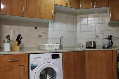 a kitchen with a washing machine in a kitchen at Newly furnished 1 Bedroom, high floor, amazing view, close to metro in Dubai