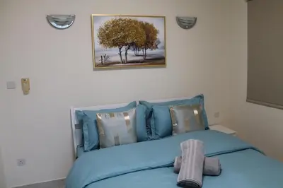 a bedroom with a blue bed with a towel on it at Newly furnished 1 Bedroom, high floor, amazing view, close to metro in Dubai