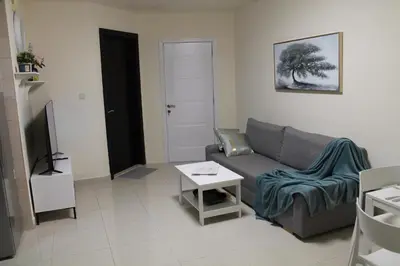 a living room with a couch and a table at Newly furnished 1 Bedroom, high floor, amazing view, close to metro in Dubai