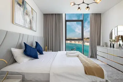 a bedroom with a large bed with a large window at Full Lagoon View Beach Access Exclusive building in Dubai