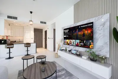 a living room with a large tv on a wall at Full Lagoon View Beach Access Exclusive building in Dubai