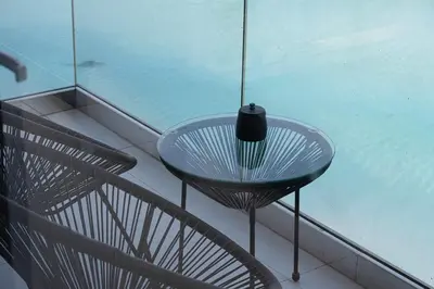 a glass table with a vase sitting on top of it at Full Lagoon View Beach Access Exclusive building in Dubai