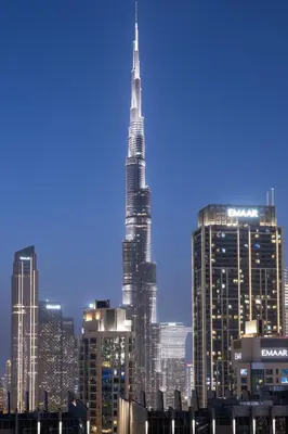 a view of the skyscrapers of a city at night at Burj khalifa and Canal views - Luxury Apartments for Rent in Dubai Business Bay in Dubai
