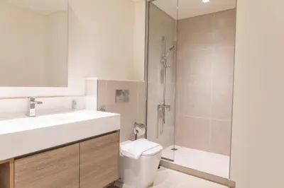 a bathroom with a shower and a toilet and a sink at Elegant 1 bedroom in Creek Edge in Dubai