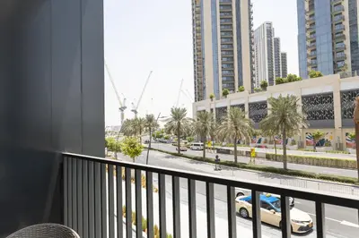 a balcony with a view of a street and buildings at Elegant 1 bedroom in Creek Edge in Dubai